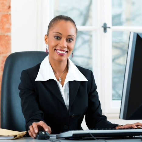 Smiling woman working at office desk.